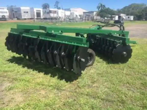 AgKing 24-plate trailing plough attached to a tractor